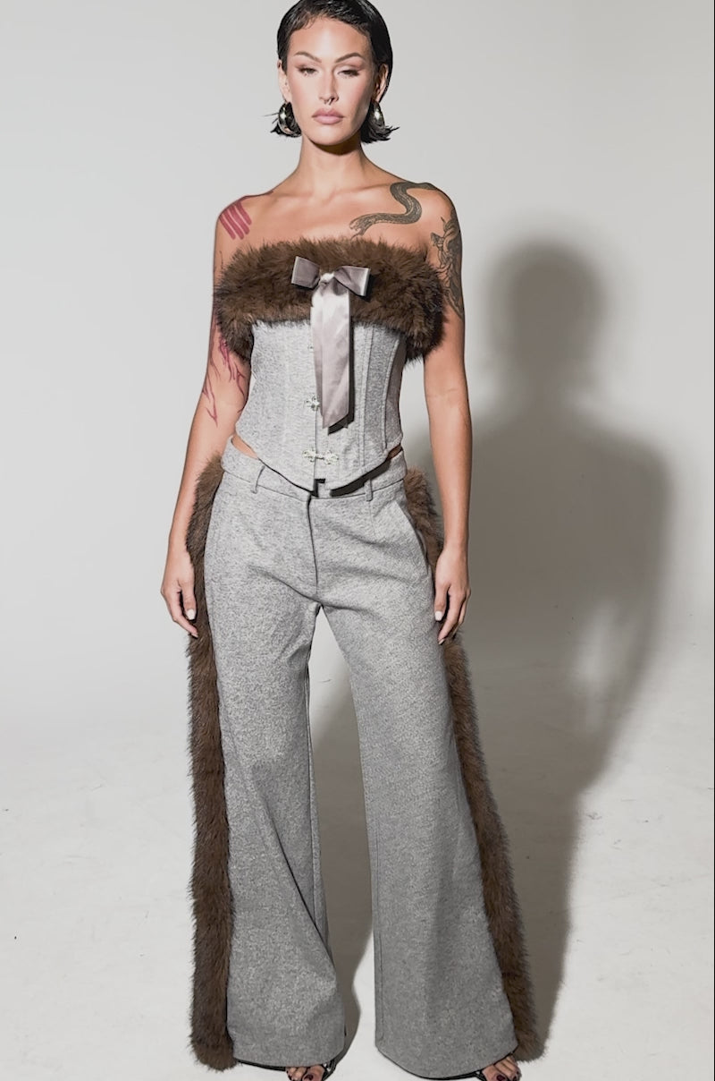 Video of woman modeling the HALLE FUR TRIM WIDE LEG PANT, featuring wool-like fabric and brown faux fur trim along the sides, styled with a matching gray top for a sleek, modern look.