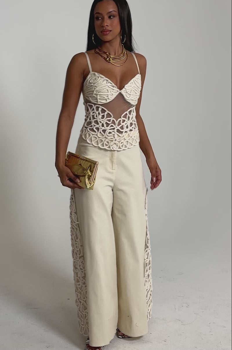 A video of a woman wearing wide-leg pants and the NEVER LOSE ME ROPE CORSET. 