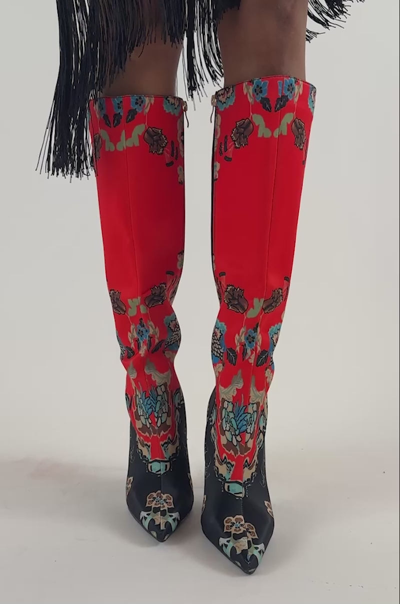 Video of a woman modeling the AKIRA GOLD FLORIQUE Floral Multi Color Stiletto Satin Boot with pointed toes and high heels.