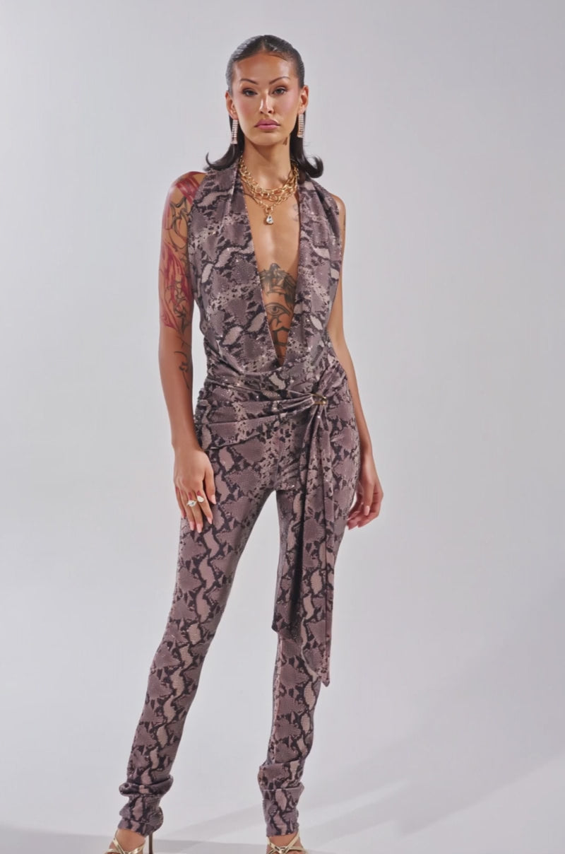 Video of woman modeling the VENOM KISS RHINESTONE HALTER TOP with a deep V-neck and snake print
