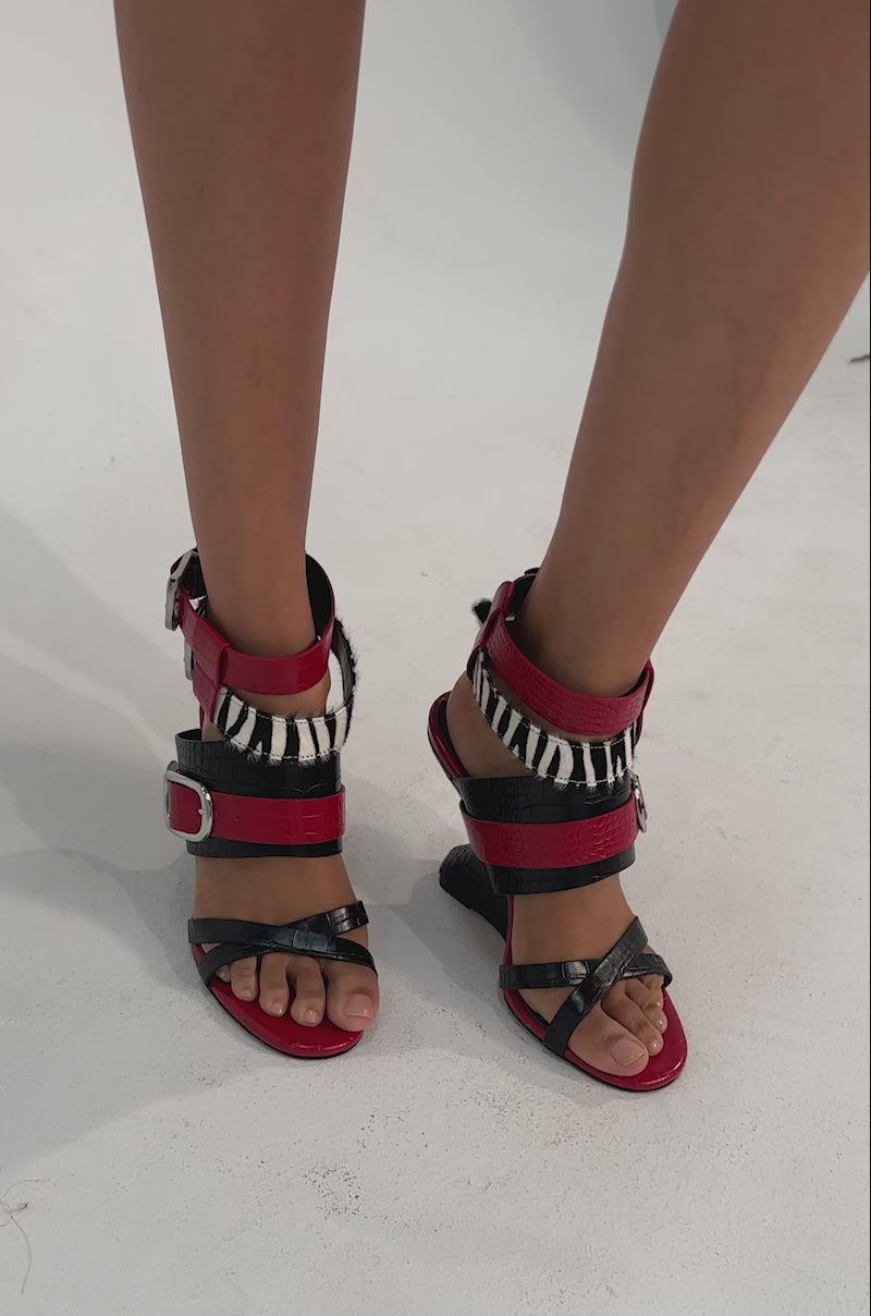 A video of a person wearing the AZALEA WANG ISKRA Red Multi Strap Novelty Wedge Sandal.