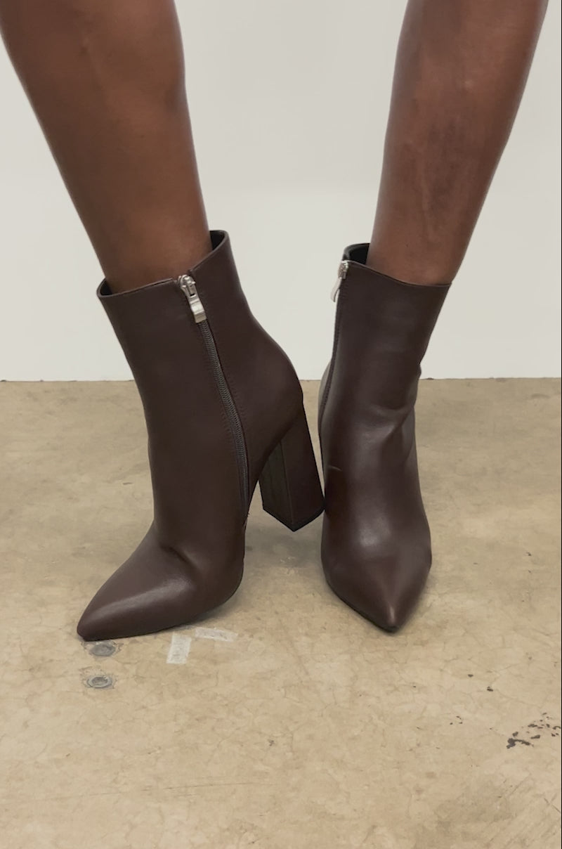 Video of woman modeling the AZALEA WANG JESSABELL Brown Pointed Toe Bootie with side zippers.