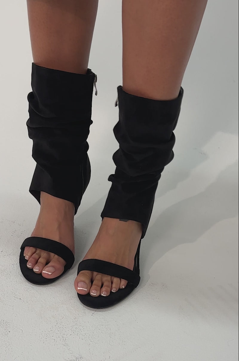 Video of woman modeling the AZALEA WANG KYVELISA BLACK WEDGE OPEN TOE BOOTIE. 