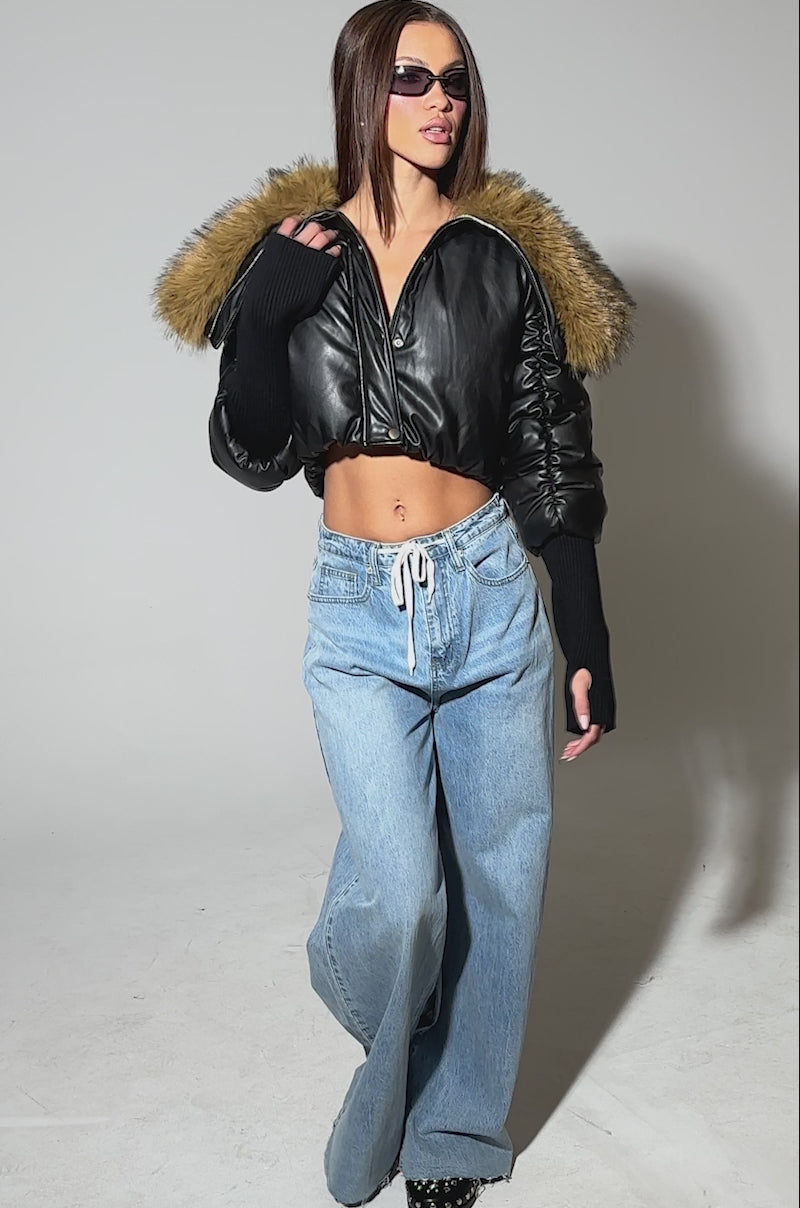 Video of woman modeling the KICKBACK FUR TRIM BOMBER, sunglasses, and blue drawstring jeans.