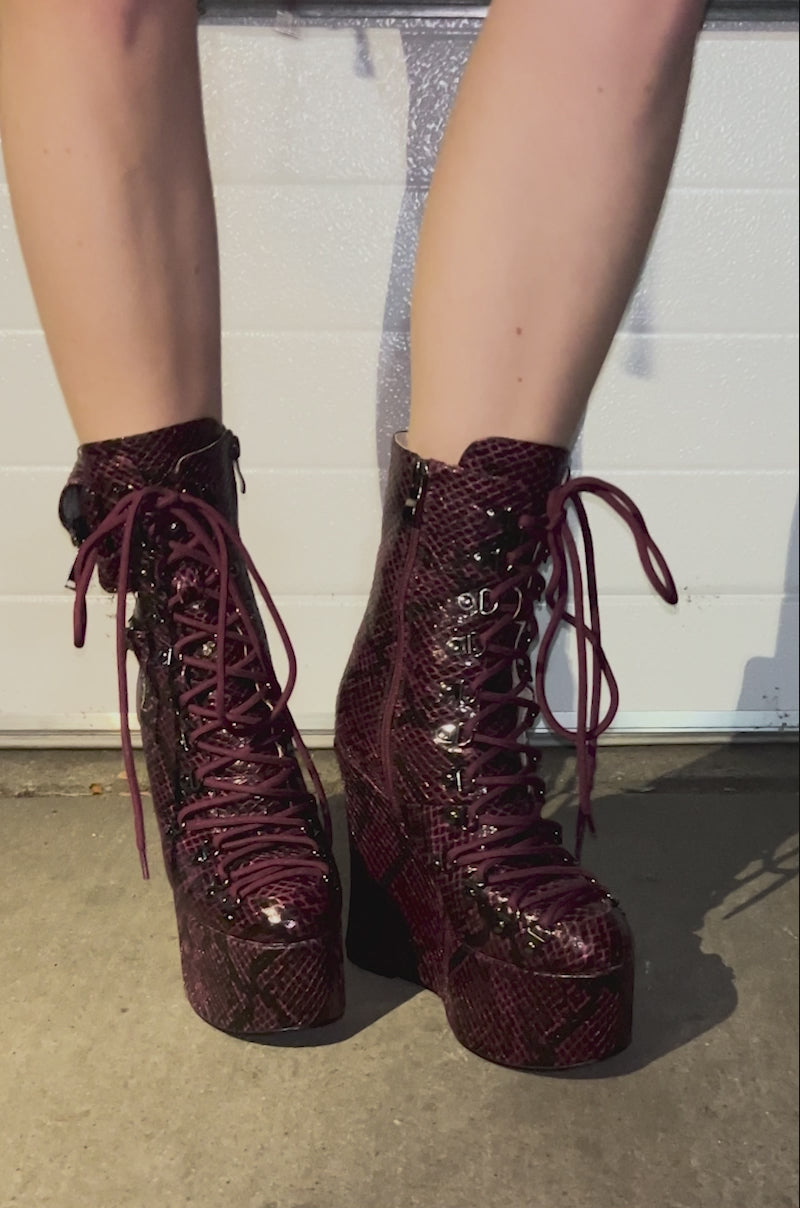 Video of a person showing off all angles of the AZALEA WANG KAPULE BURGUNDY SNAKE PLATFORM BOOTIE 
