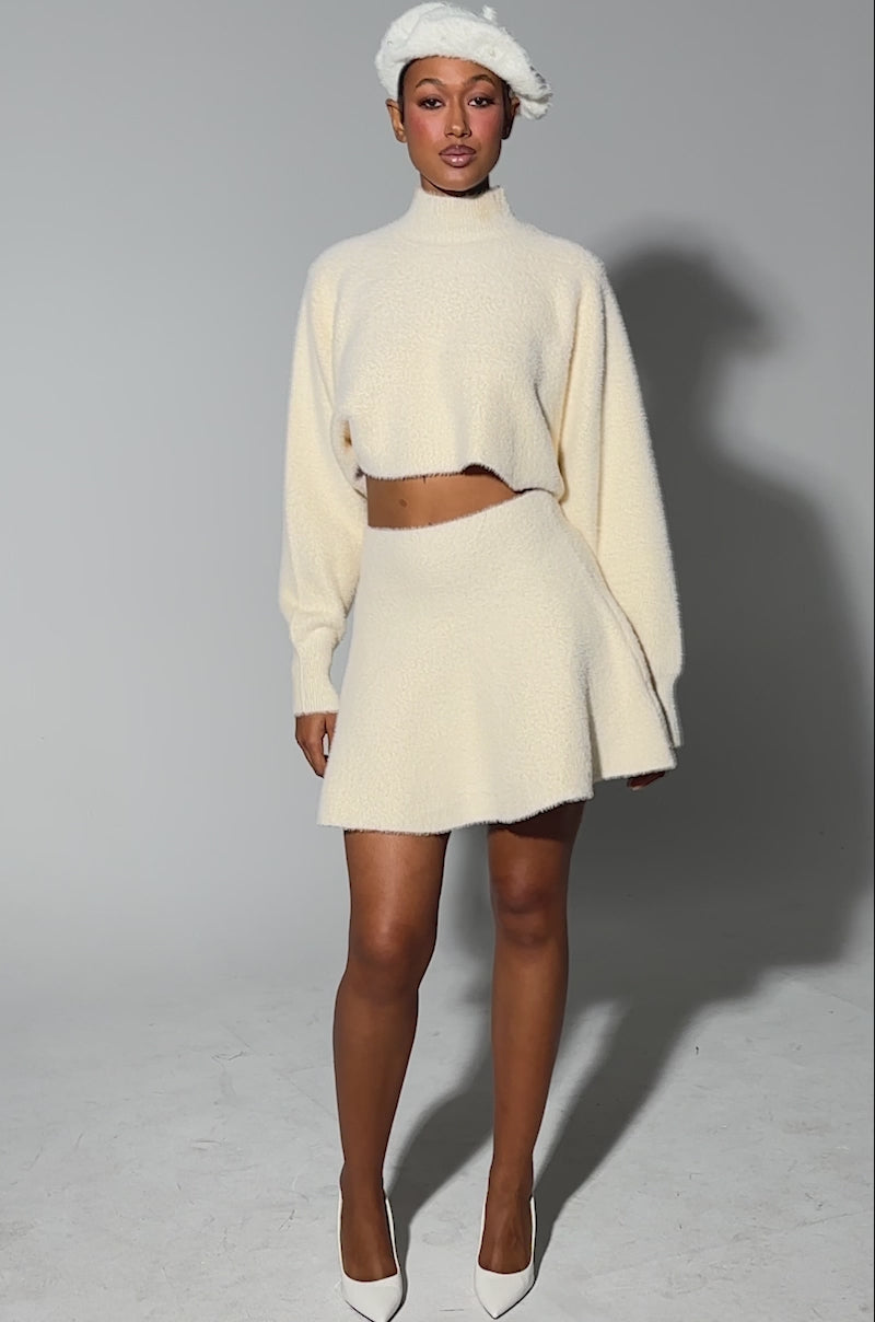 Video of person modeling the CUDDLE UP FUZZY MINI SKIRT IN IVORY