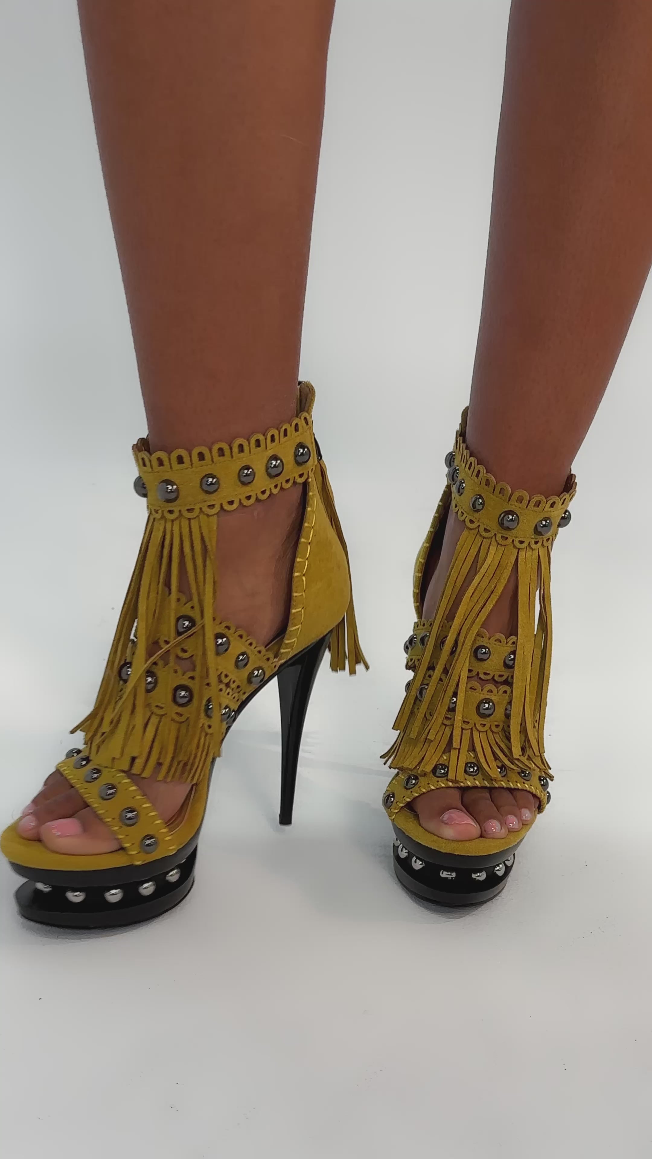 Video of woman modeling the AKIRA GOLD MAROVA MUSTARD NOVELTY PLATFORM FRINGE EMBELLISHED SANDAL, featuring metallic studs and bold mustard fringe