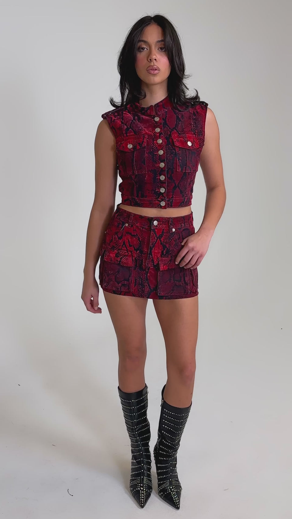 A video of a woman in the FLOATING IN BETWEEN SNAKE BUTTON DOWN top with a matching skirt.