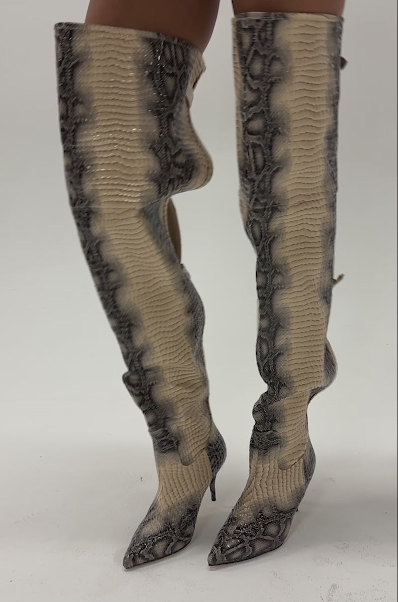 Video of woman modeling the AZALEA WANG MOONREEL SNAKE THIGH HIGH BOOT—tall, snake print stiletto boots with buckles.