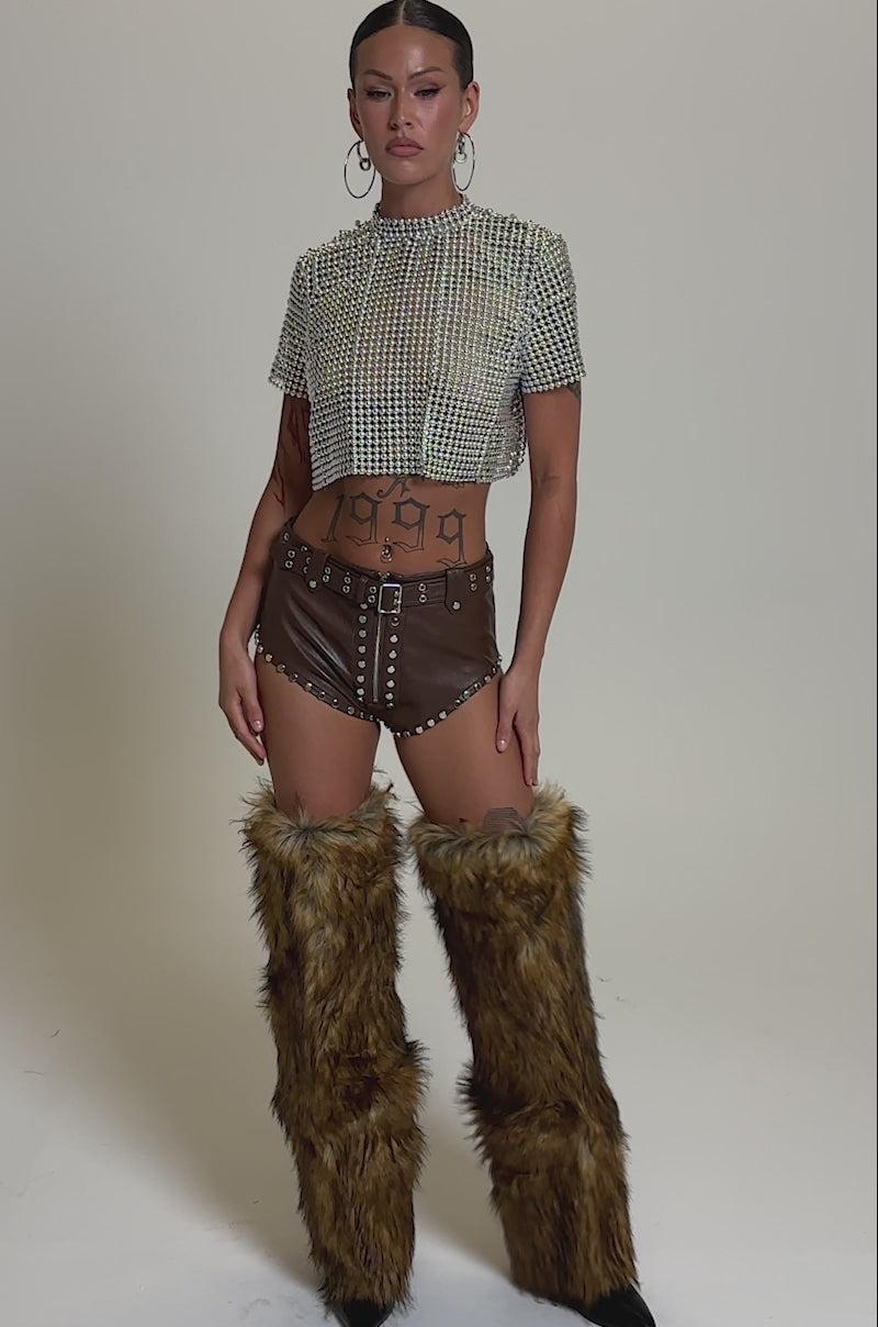 A video of a person in the BABY PLZ FAUX LEATHER STUD HOT SHORT IN BROWN.
