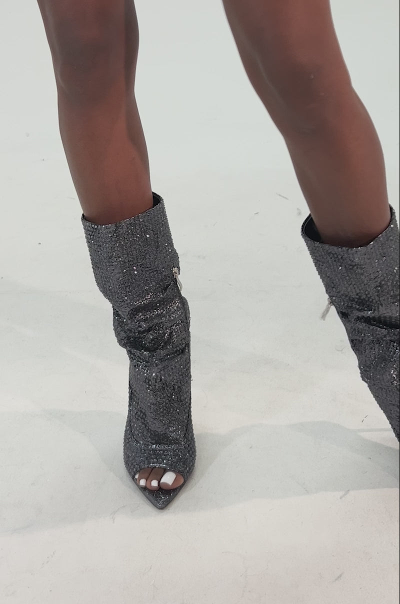 Video of woman modeling the AZALEA WANG PHOTINE BLACK MULTI SPARKLE OPEN TOE STILETTO BOOTIES