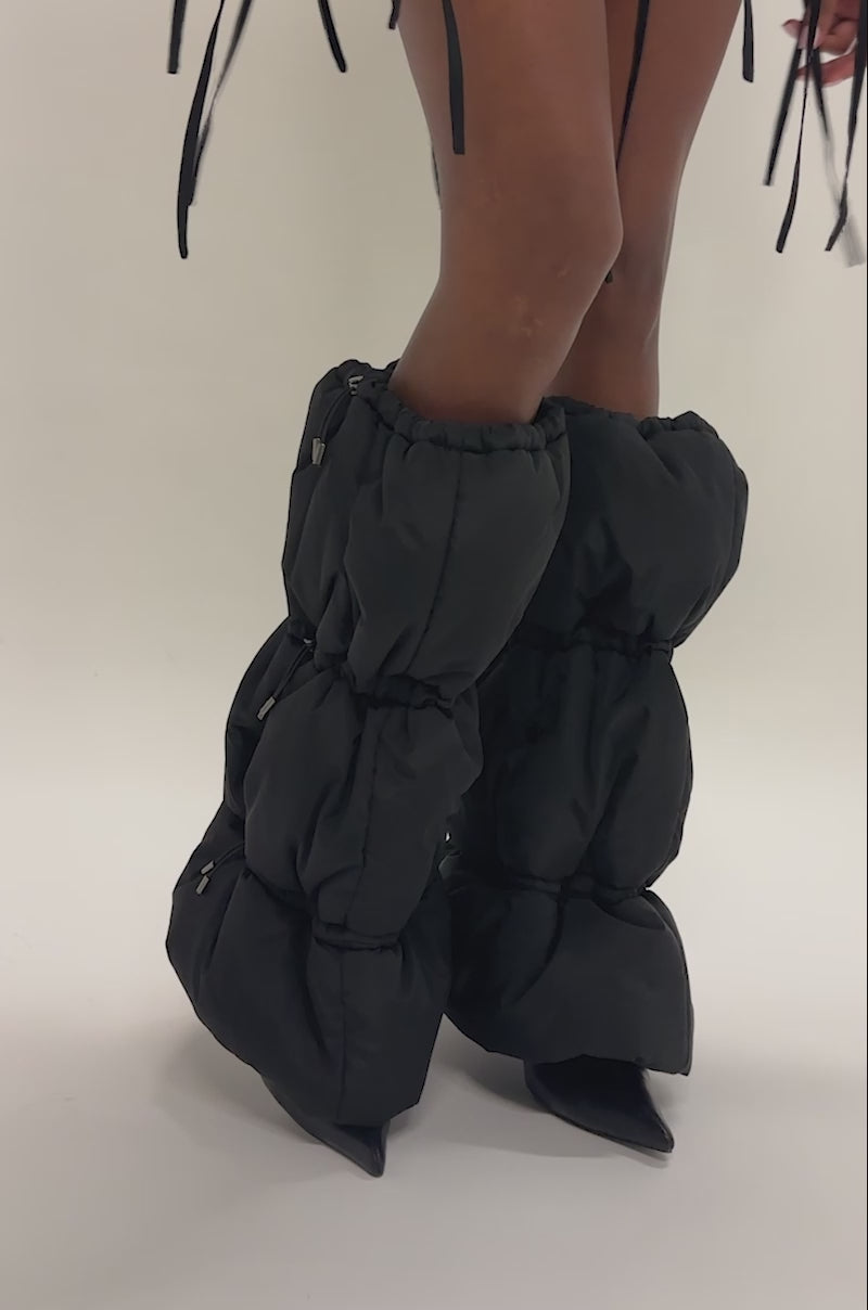 Video of a woman modeling the AKIRA GOLD FAUSTINE BLACK PUFFER BLACK STILETTO BOOT.
