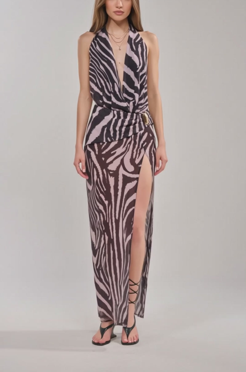 Video of woman modeling the INVITE ONLY PRINTED MAXI DRESS IN ZEBRA, styled with black strappy heels