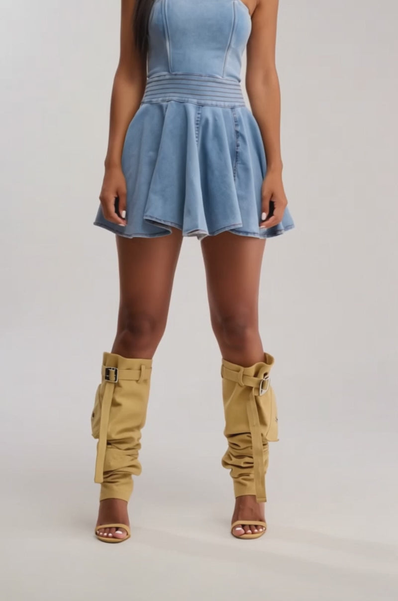 Video of woman modeling the SWEET LIKE ME STRAPLESS DENIM MINI DRESS IN MEDIUM BLUE, featuring a fitted bodice and flared, pleated skater-style skirt that exudes effortless summer style against a simple light background.