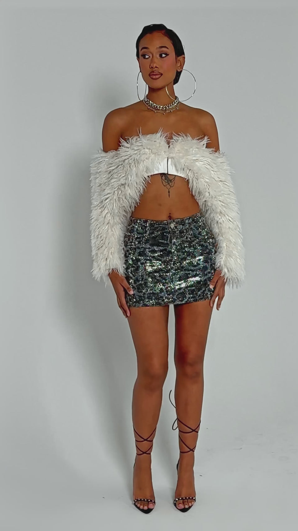 Video of woman modeling the CHEETAH SISTER RHINESTONE MINI SKIRT 