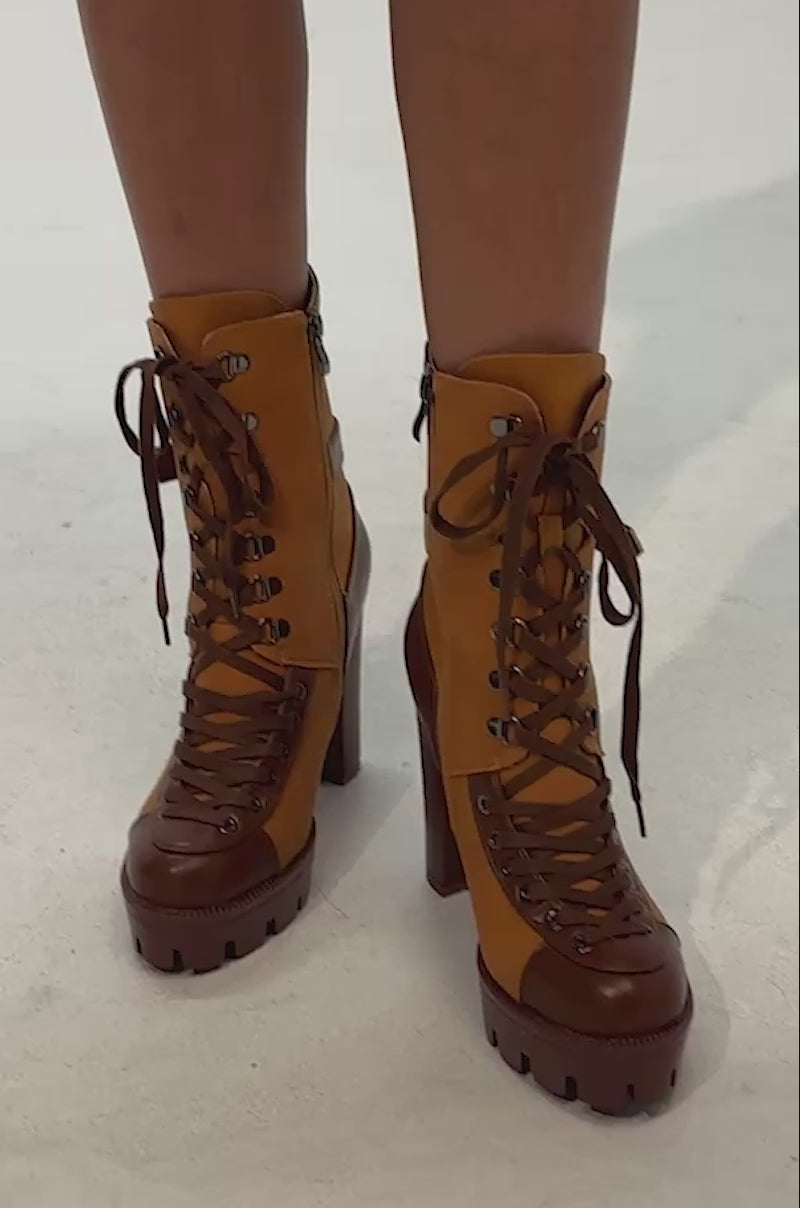 Video of woman modeling the AZALEA WANG BARRINGTON Tan Color Blocked Sporty Chunky Booties with thick soles and side zippers. 