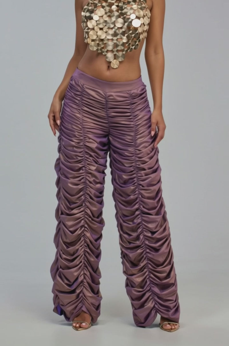 Video of a woman modeling the WOW WOW WOW RUCHED PANT, a pair of high-waisted, ruched rose gold pants.