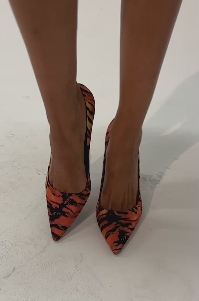 Video of a woman modeling the AZALEA WANG NIKOMEDES TIGER PRINT STILETTO PUMP, featuring a bold orange and black tiger stripe pattern and pointed toe design.
