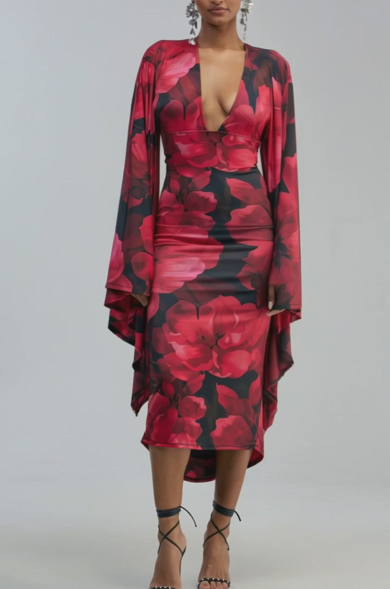 Video of a woman modeling the SHINY LIKE ME MAXI DRESS IN RED FLORAL—a red floral-print maxi dress featuring a deep V-neck and flared sleeves
