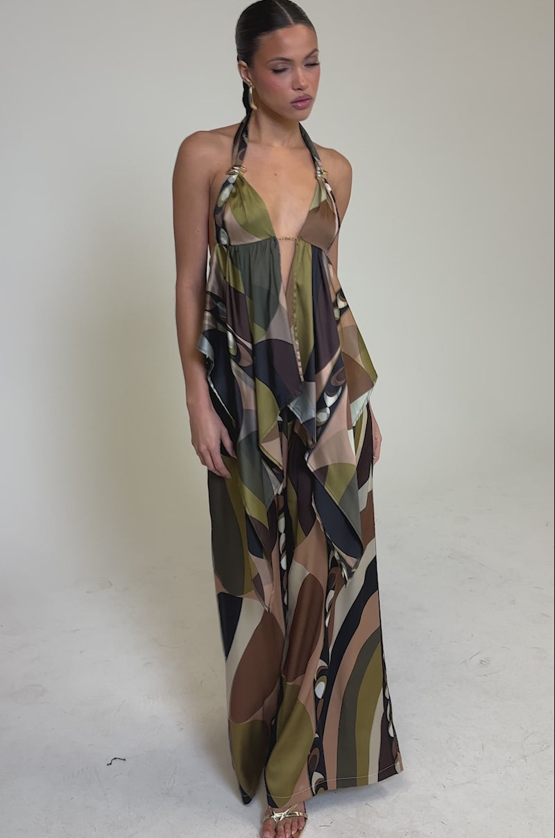 Video of woman modeling the WILD AND FREE TROUSER, featuring palazzo-style wide legs and an abstract geometric pattern in earthy olive green, brown, and beige. 