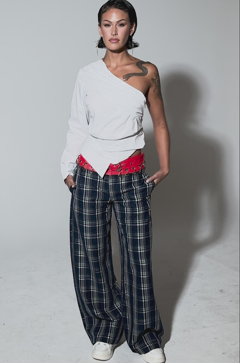 Video of woman modeling the FREE STYLE LIFE PLAID TROUSER—loose-fitting, blue and white plaid with a red corset-style waistband and wide legs—paired with white shoes