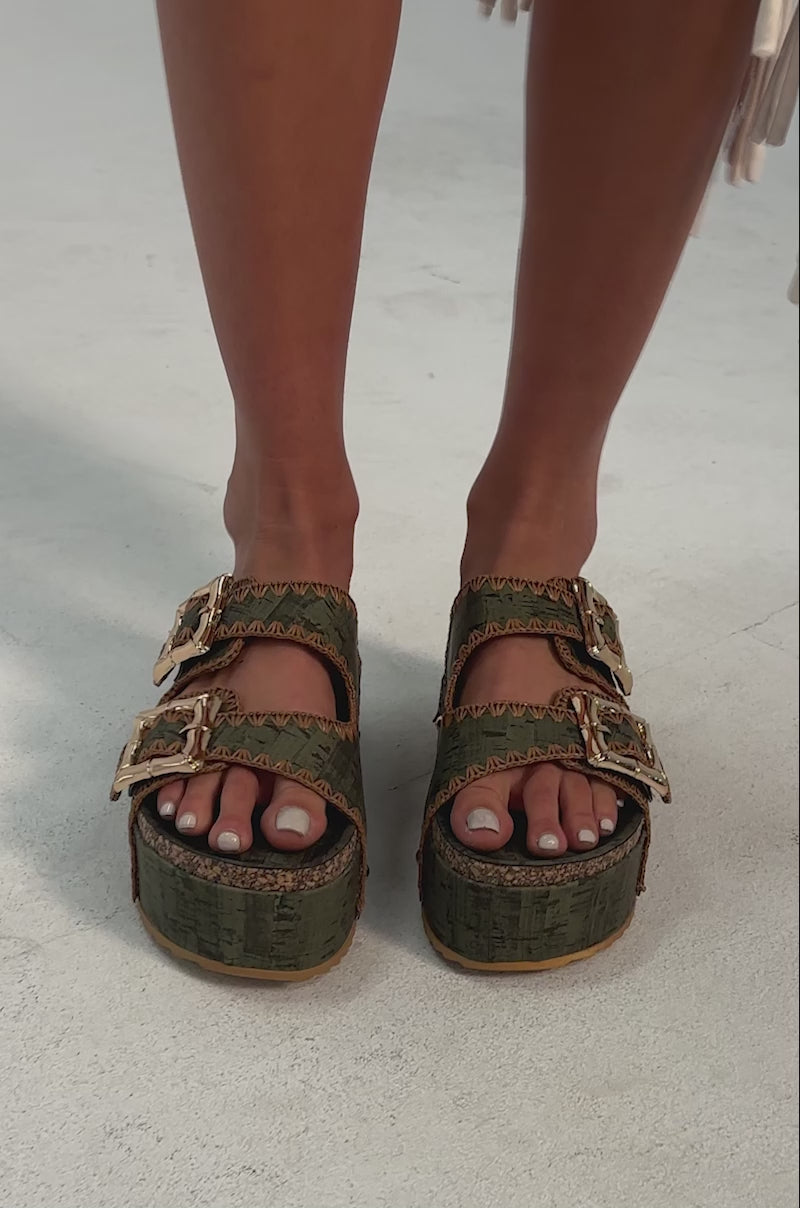 A video of a person wearing the AZALEA WANG OHKAY GREEN FLATFORM STUD EMBELLISHED SLIP ON SANDALS.