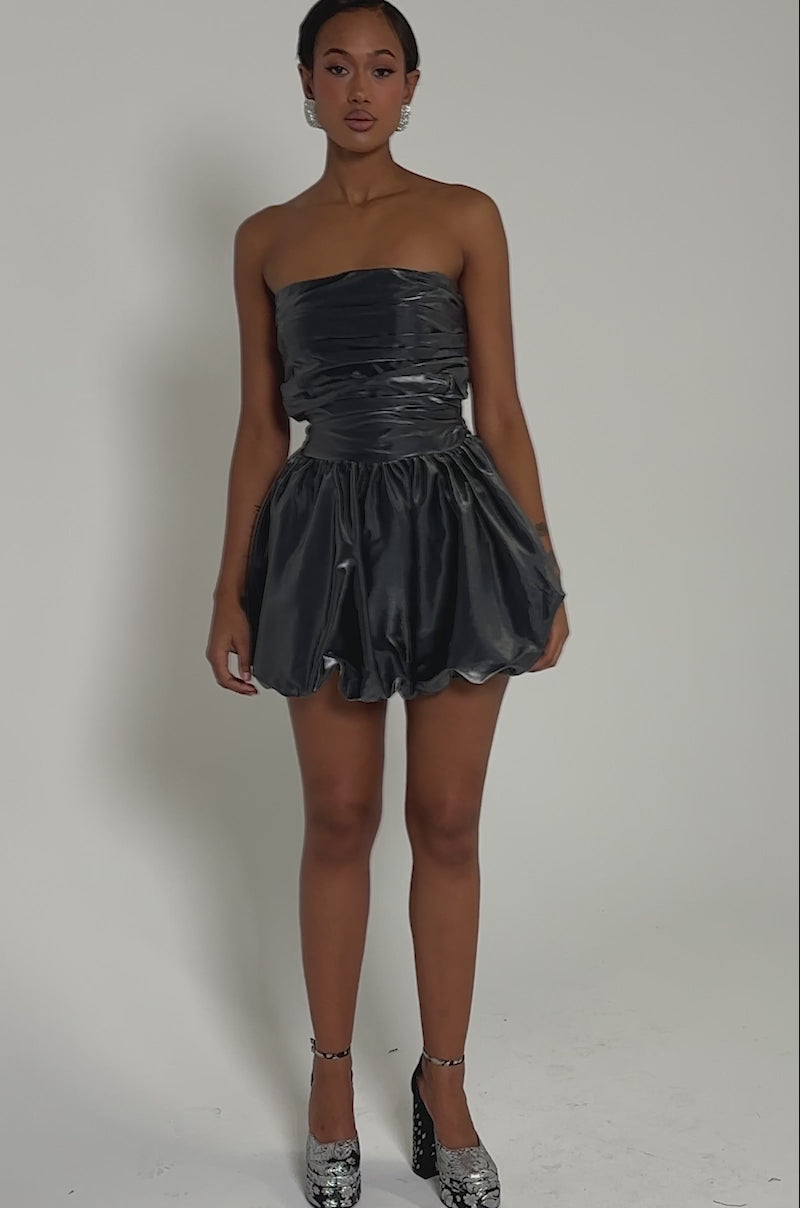 Video of woman modeling the GET WITH IT MINI DRESS, featuring a strapless metallic design with a ruched bodice and voluminous bubble skirt