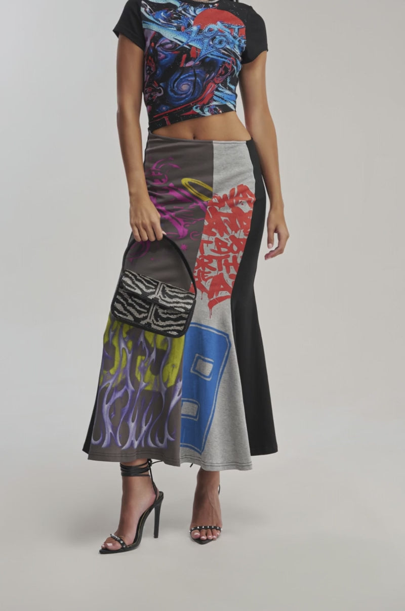 Video of a woman modeling the RACE YA GRAPHIC MAXI DRESS WITH SIDE CUTOUT.