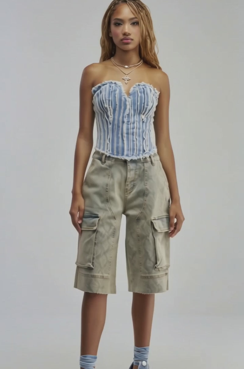 Video of a woman modeling the HERE FOR A GOOD TIME CORSET TOP—a distressed denim corset featuring a strapless sweetheart neckline, frayed edges, and vertical white stripes.