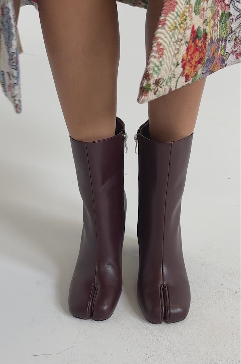 A video of a personwearing AZALEA WANG BILHA Burgundy Split Toe Block Boote ankle boots with side zipper.