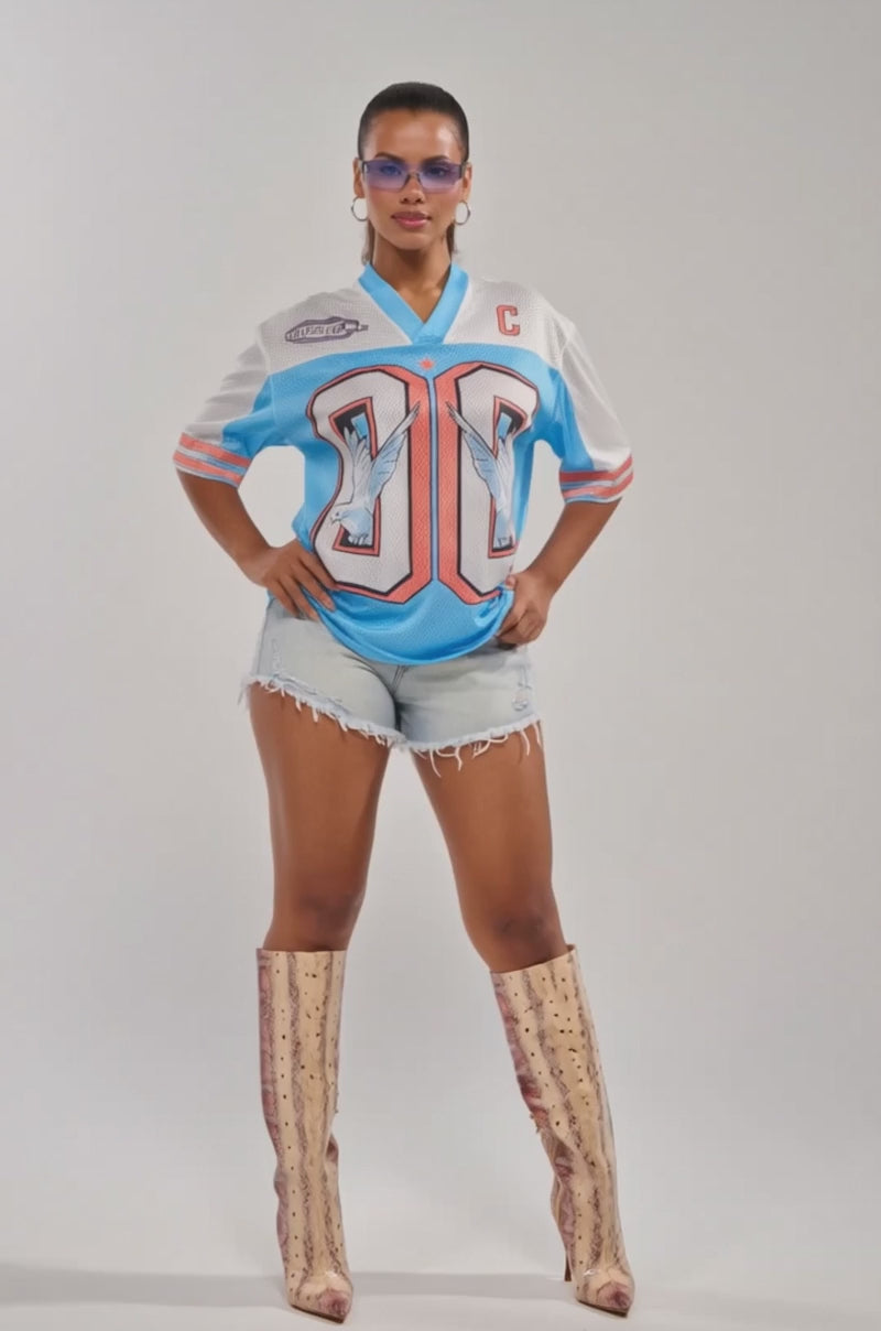 Video of woman modeling the FLY AWAY JERSEY with a dove graphic 