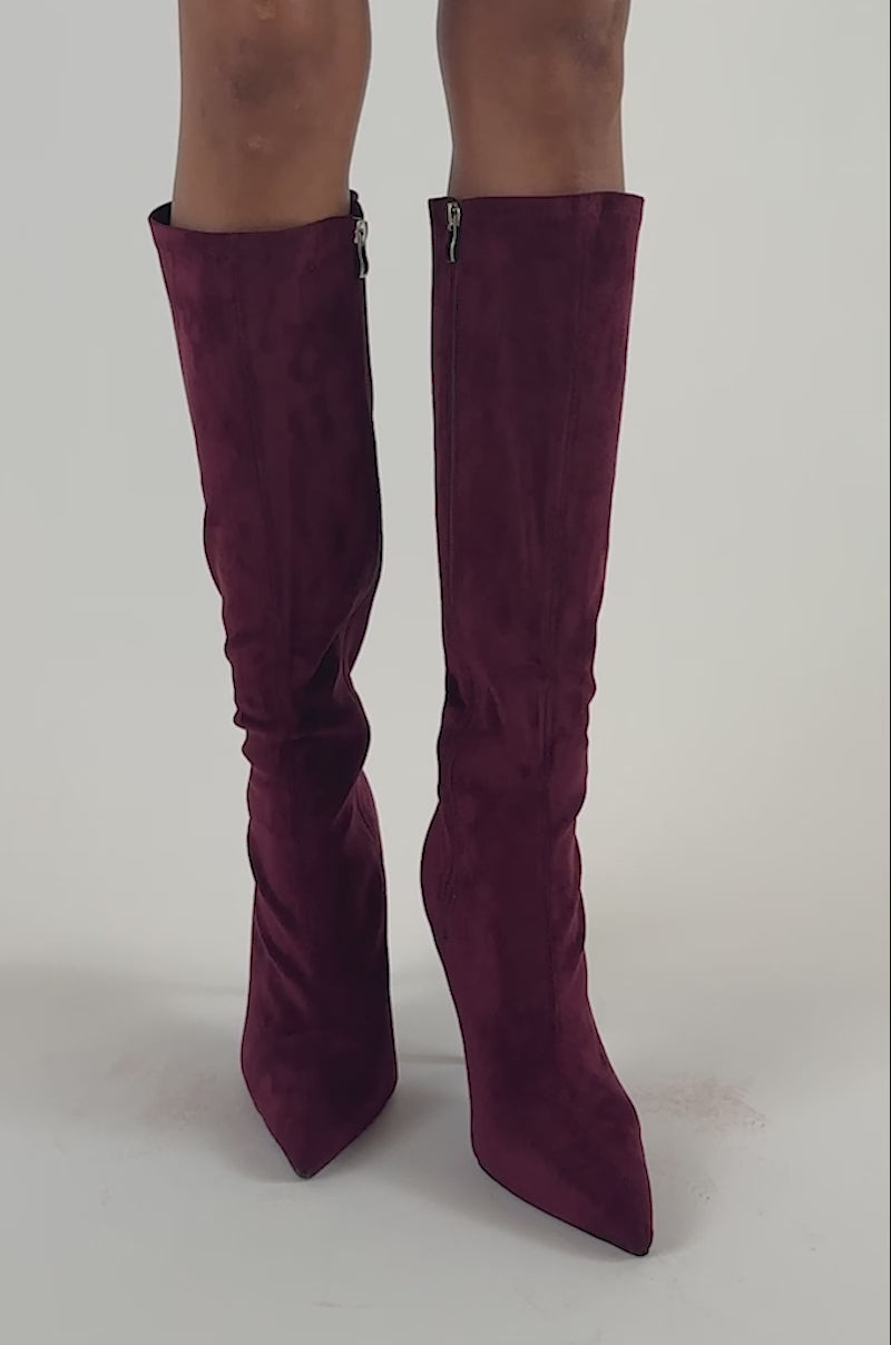 Video of a woman modeling the AZALEA WANG CALANA JEWEL 4 WAY STRETCH SUEDE STILETTO BOOT in burgundy.