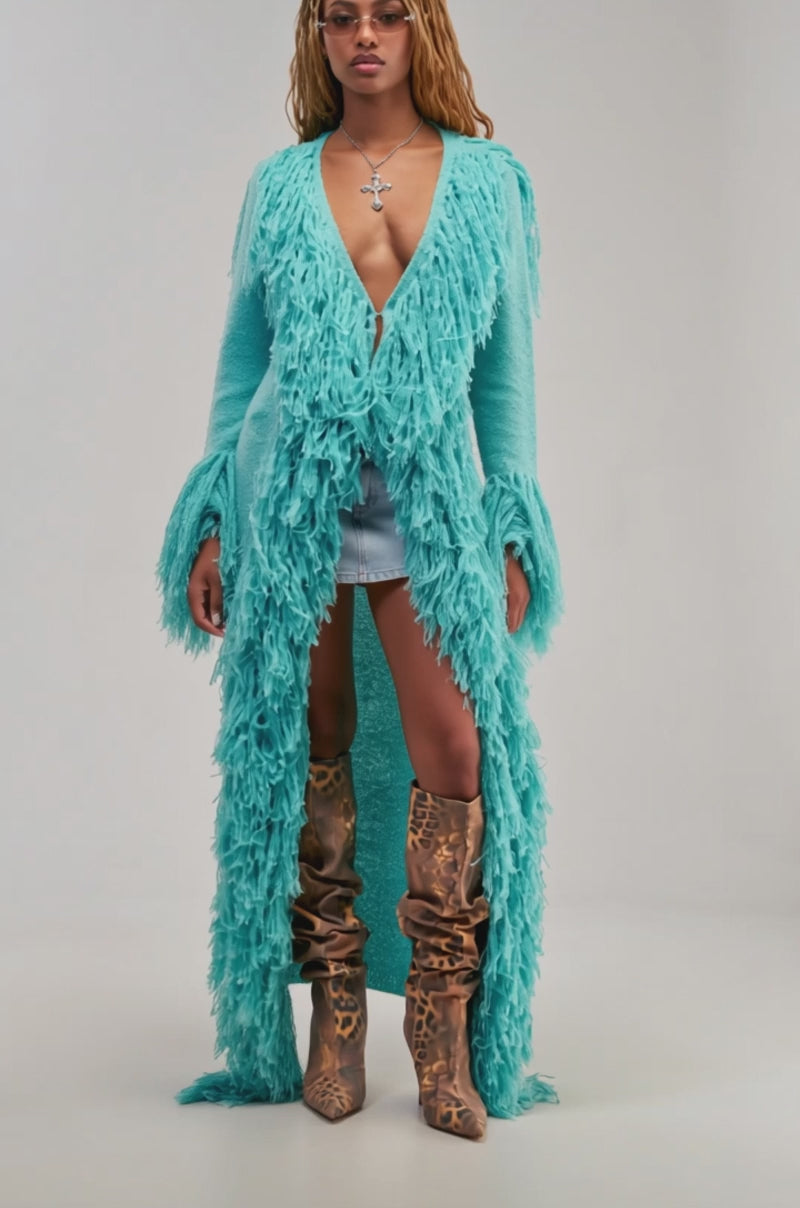 Video of a woman modeling the BURRR IT’S COLD OUTSIDE FRINGE OVERSIZED SWEATER IN TURQUOISE.