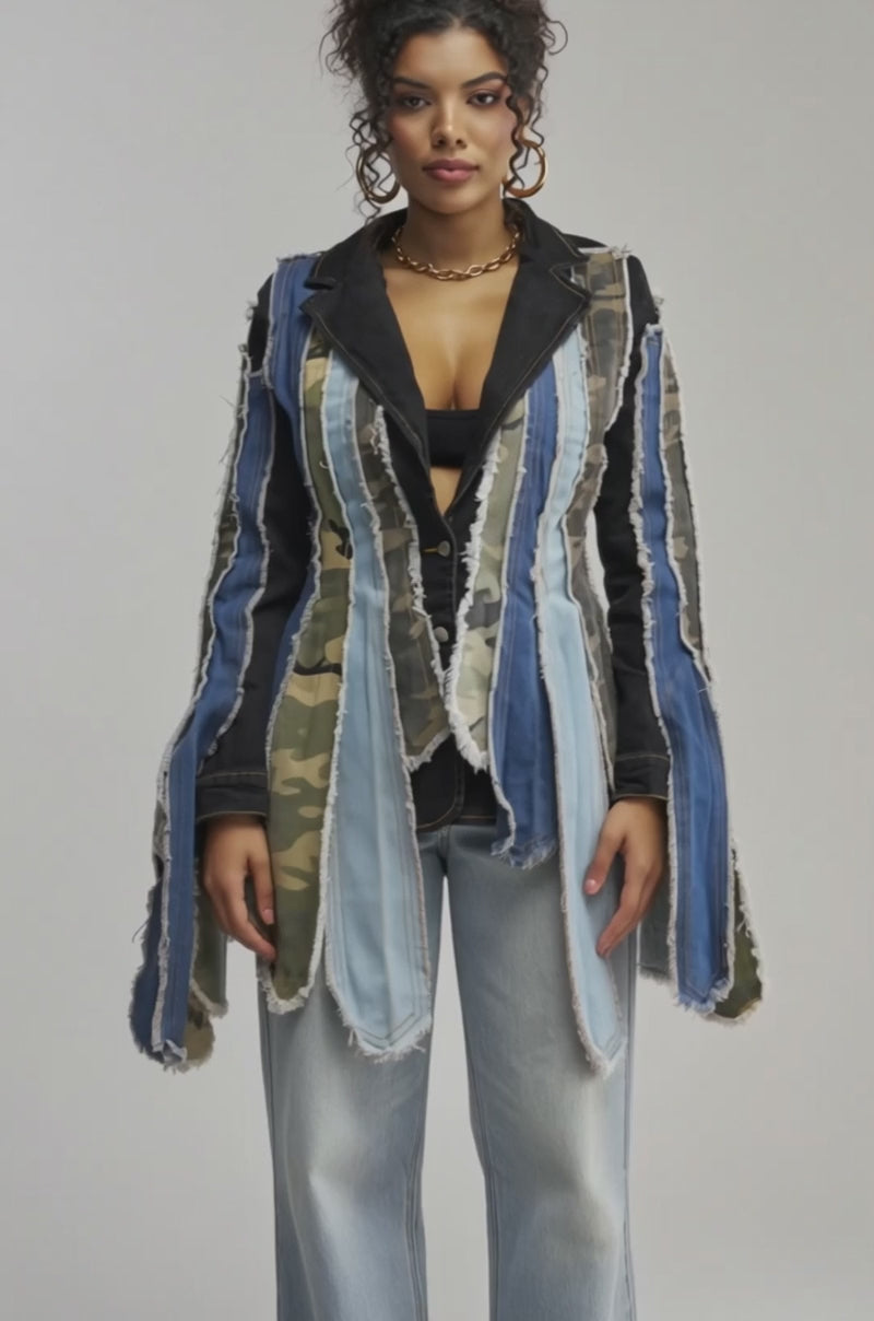 Video of woman modeling the HERE FOR IT PATCHWORK BLAZER, featuring denim and camouflage fabric accents, layered over a black top and light blue jeans against a simple light background.