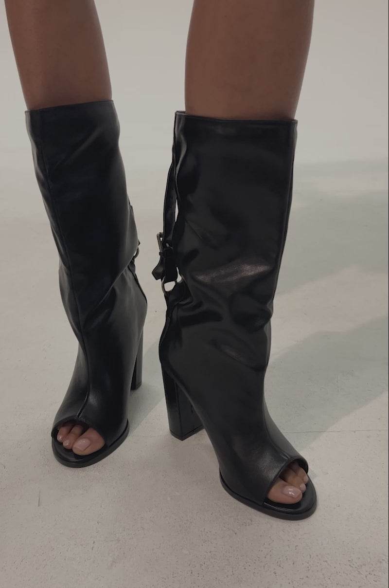 Video of woman modeling the AKIRA GOLD REMIX BLACK OPEN TOE BLOCK BOOTIE with a mid-calf shaft and block heel
