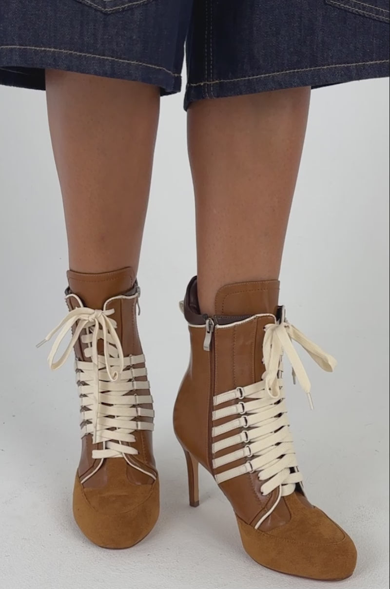 Video of a woman modeling the AZALEA WANG ELEVEN BROWN STILETTO SPORTY BOOTIE.