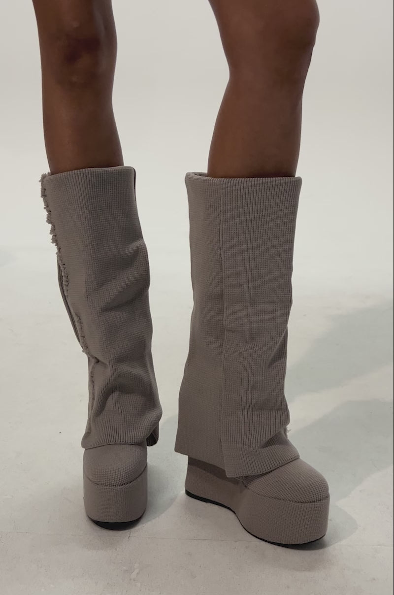 Video of woman modeling the AZALEA WANG FRANKEYE BEIGE FLATFORM BOOTS and frayed denim shorts standing against a plain white background.