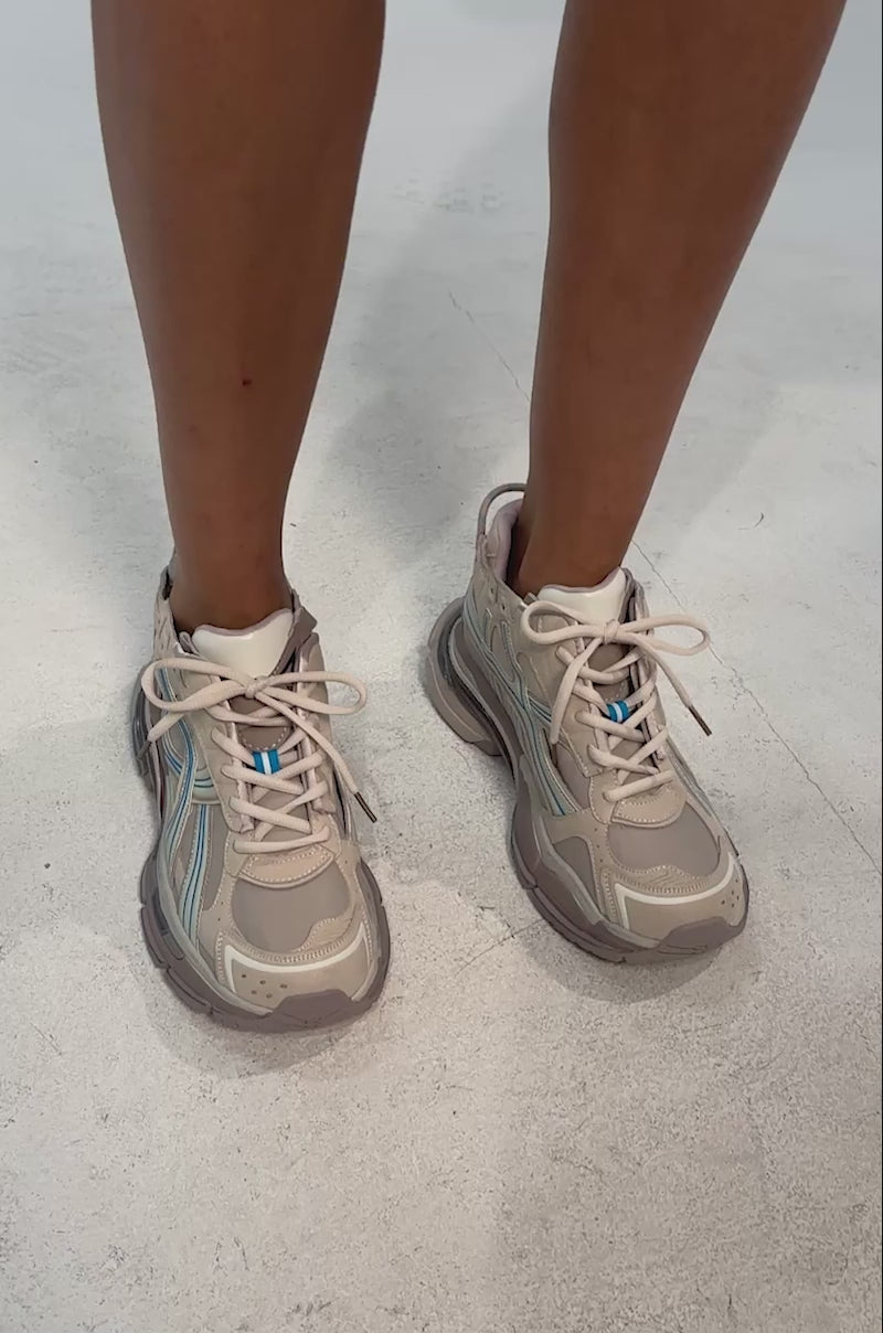 Video of woman modeling the AKIRA GOLD MELAE LIGHT GREY SNEAKER and a denim skirt