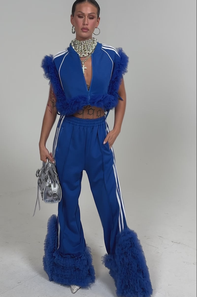 Video of woman modeling the MODERN JAM SWEATSHIRT WITH TULLE IN ROYAL BLUE, styled with large hoop earrings and a statement necklace.