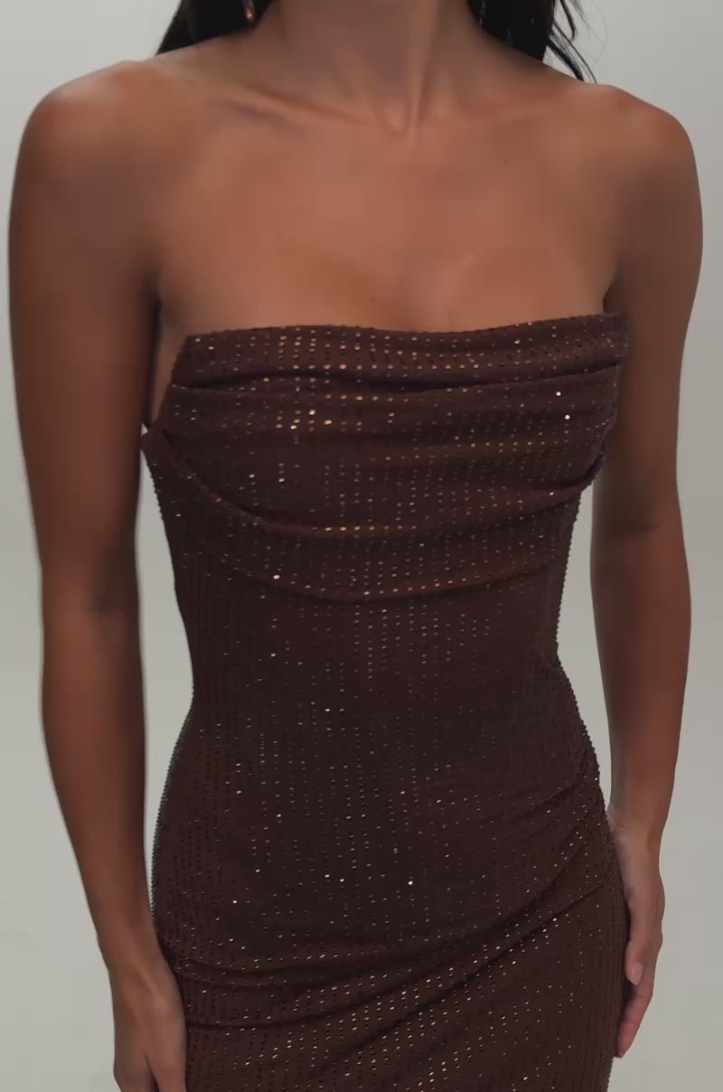 Video of a woman modeling the FULL GLAM RHINESTONE MINI DRESS IN BROWN—a fitted, strapless cocktail mini dress embellished with small metallic studs. 