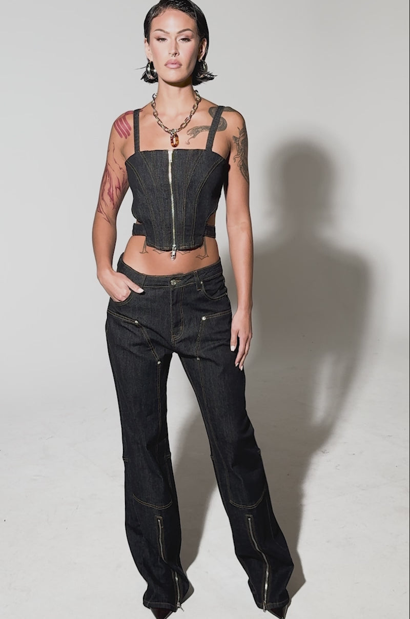 Video of woman modeling the HARDEST TO LOVE WIDE LEG DENIM—loose-fitting, high-rise jeans in dark wash denim with yellow stitching