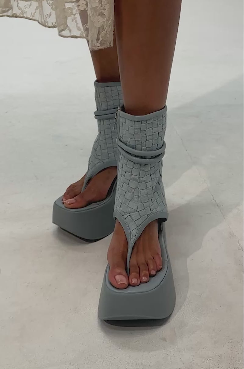 Video of woman modeling the AZALEA WANG SCULLY DENIM FLATFORM SANDAL—blue woven sandals with thick soles and side zippers