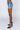 Side View Runway High Waisted Stretchy Rhinestone Jean Shorts in Medium Blue Denim