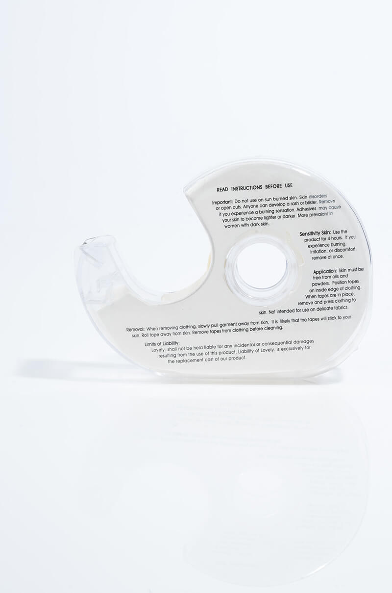 A LINGERIE TAPE dispenser made of clear plastic with printed instructions on its surface. The dispenser is photographed against a white background, emphasizing its curved design and transparent material, showcasing text that includes usage directions and safety warnings.