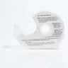 A LINGERIE TAPE dispenser made of clear plastic with printed instructions on its surface. The dispenser is photographed against a white background, emphasizing its curved design and transparent material, showcasing text that includes usage directions and safety warnings.