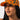 A person with long, dark hair is wearing a VON DUTCH TRUCKER HAT ORANGE CAMO. They have a neutral expression and are looking slightly upwards, with a plain white background behind them.