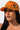 A person with long, dark hair is wearing a VON DUTCH TRUCKER HAT ORANGE CAMO. They have a neutral expression and are looking slightly upwards, with a plain white background behind them.