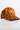 A VON DUTCH TRUCKER HAT ORANGE CAMO with an orange and green camouflage pattern, featuring a red patch and embroidered logo on the front, displayed on a clean white background.