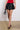 Front View Yours Truly Faux Leather Micro Mini Skort In Black