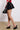 Side View Yours Truly Faux Leather Micro Mini Skort In Black